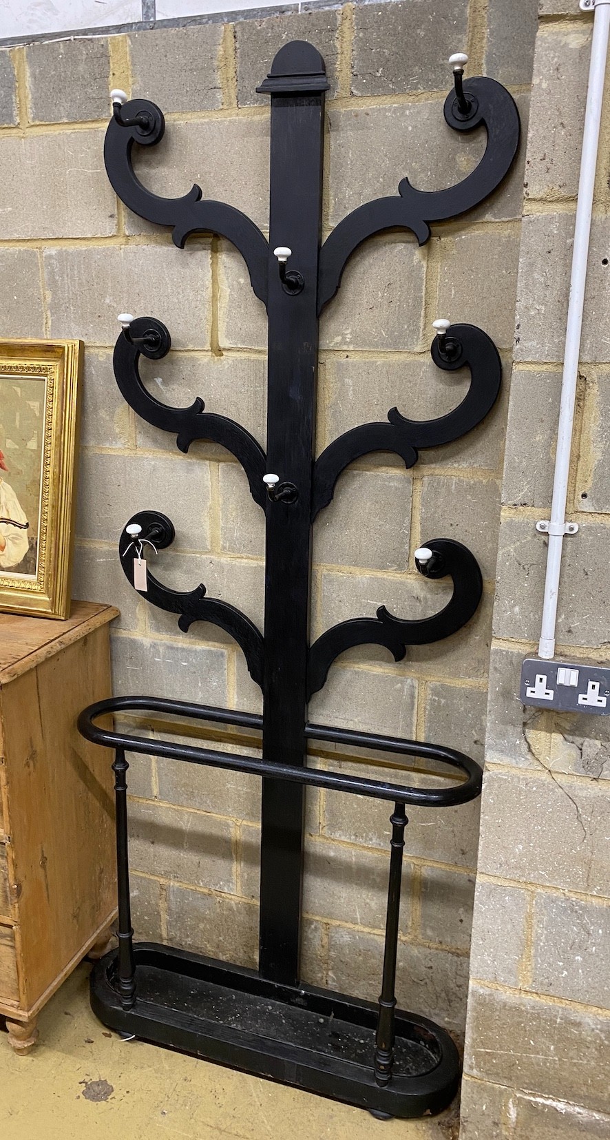 A Victorian hall stand with tin drip tray, later painted black, width 90cm, height 215cm